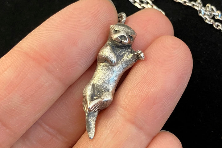 A Pair of Sea Otters Holding Hands Sterling Silver Pendants / Necklaces