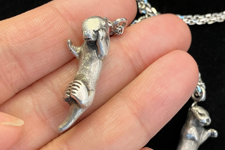 A Pair of Sea Otters Holding Hands Sterling Silver Pendants / Necklaces