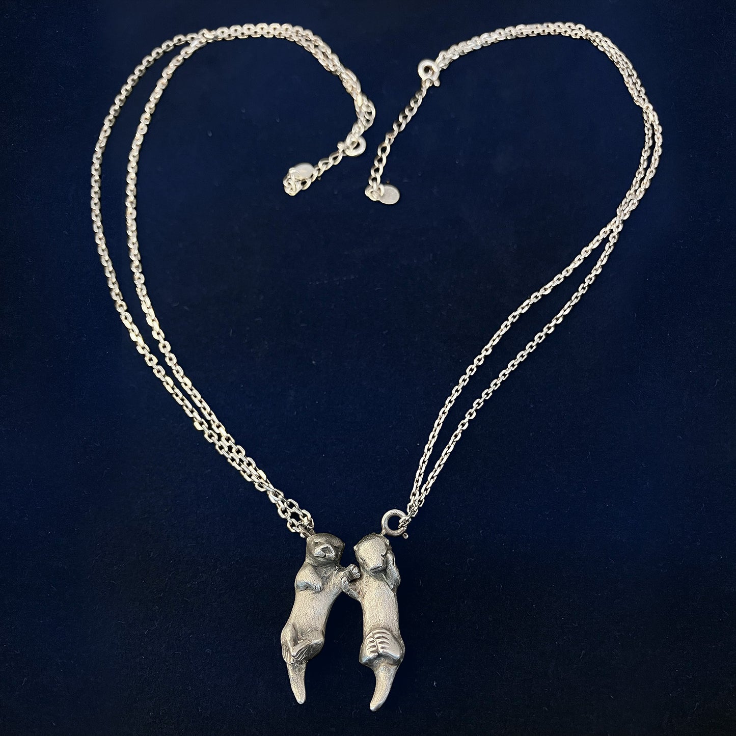 A Pair of Sea Otters Holding Hands Sterling Silver Pendants / Necklaces