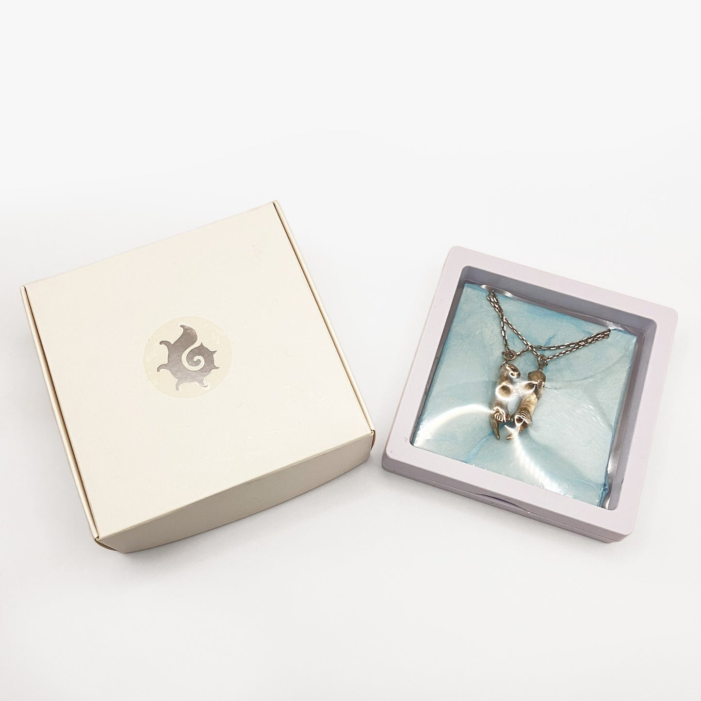 A Pair of Sea Otters Holding Hands Sterling Silver Pendants / Necklaces