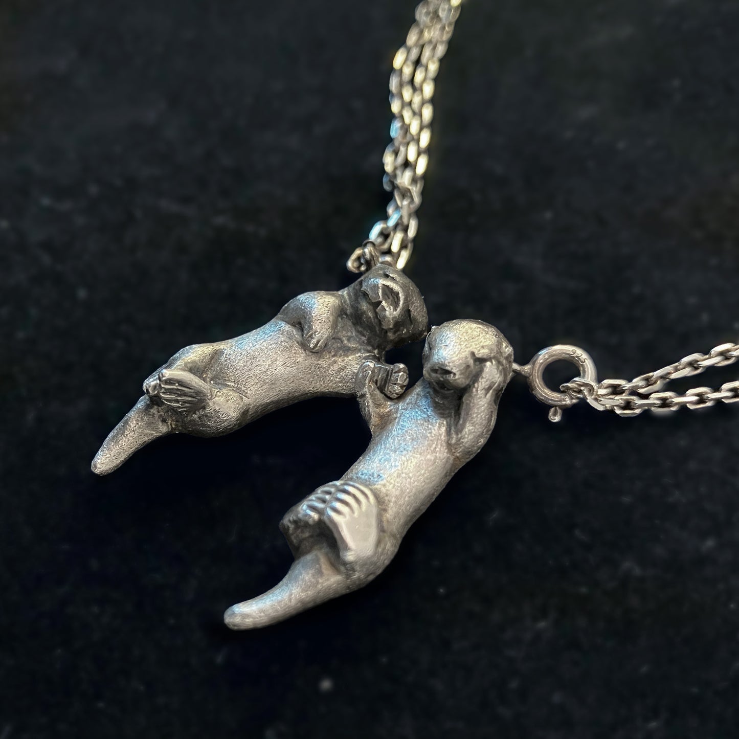A Pair of Sea Otters Holding Hands Sterling Silver Pendants / Necklaces