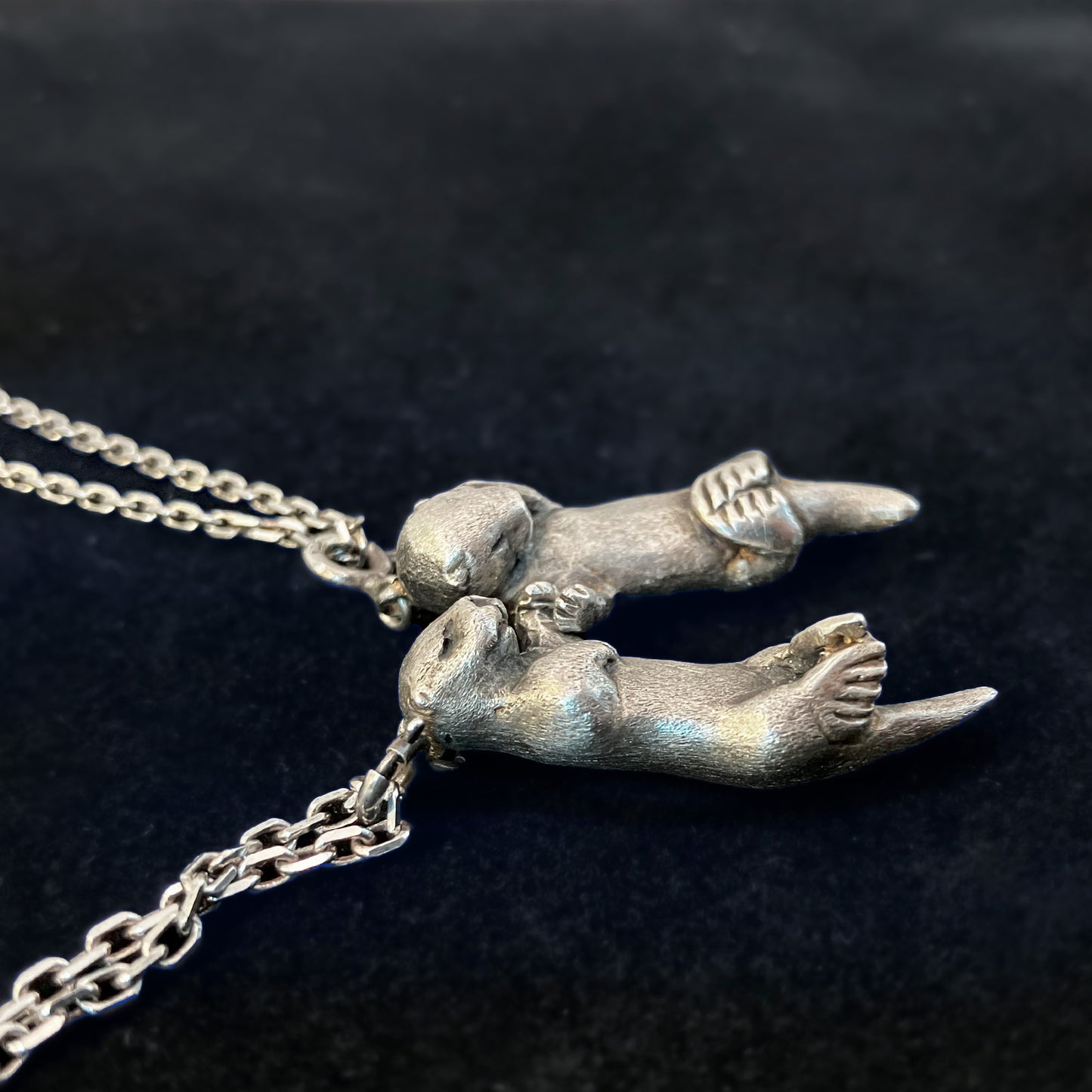 A Pair of Sea Otters Holding Hands Sterling Silver Pendants / Necklaces